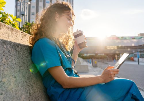 Beautiful young nurse or doctor strolling in the city Beautiful young nurse or doctor strolling in the city