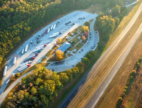 Large truck stop with resting area near busy american interstate freeway Large truck stop with resting area near busy american interstate freeway